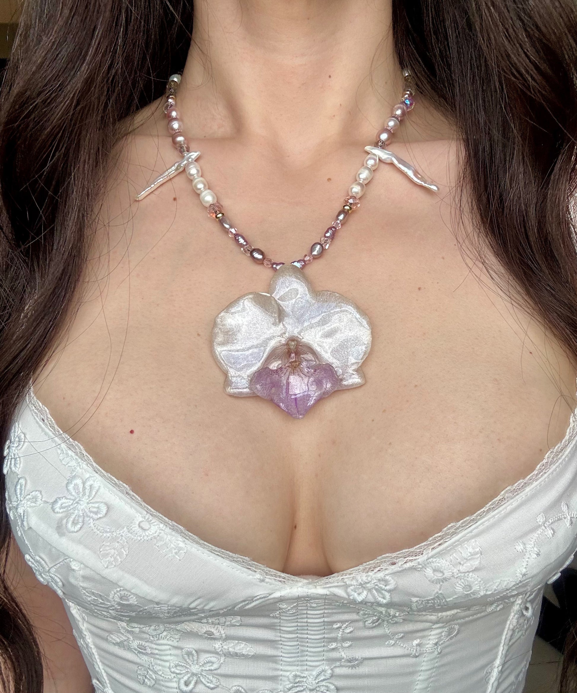 White orchid pendant necklace with freshwater baroque pearl and crystal beading.
